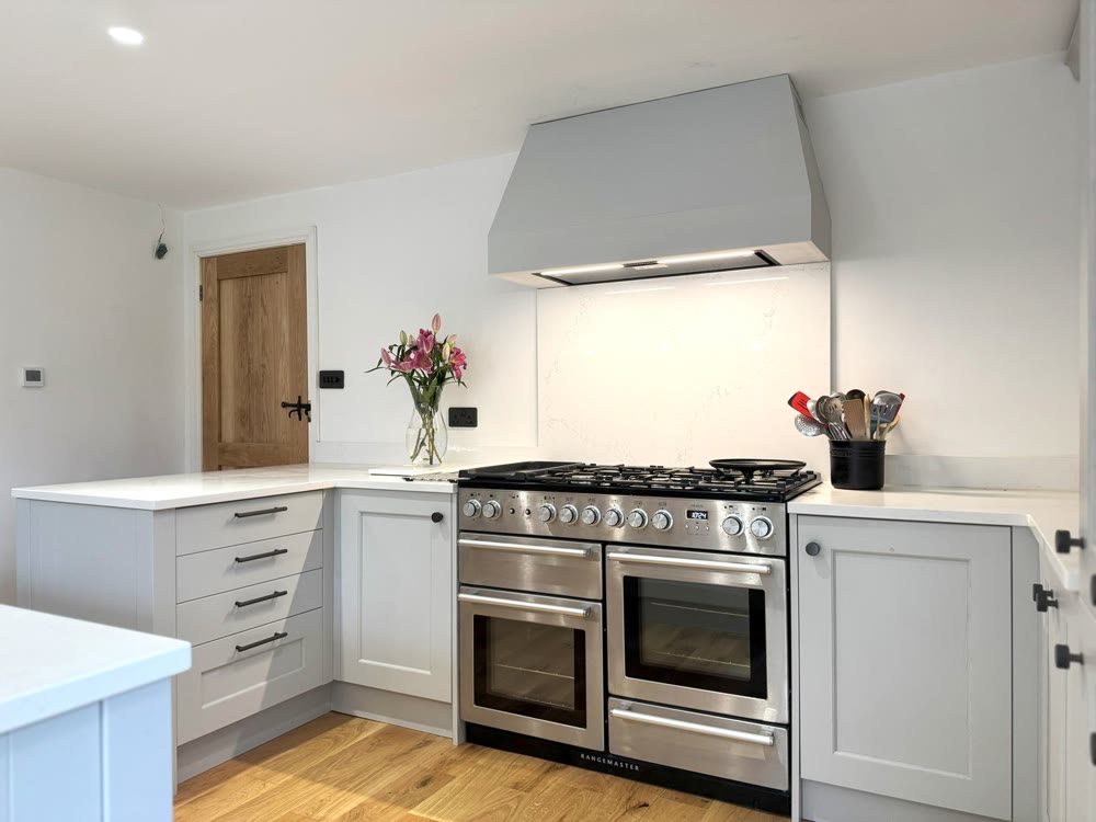 A bright painted shaker kitchen with a range cooker, made by CEK