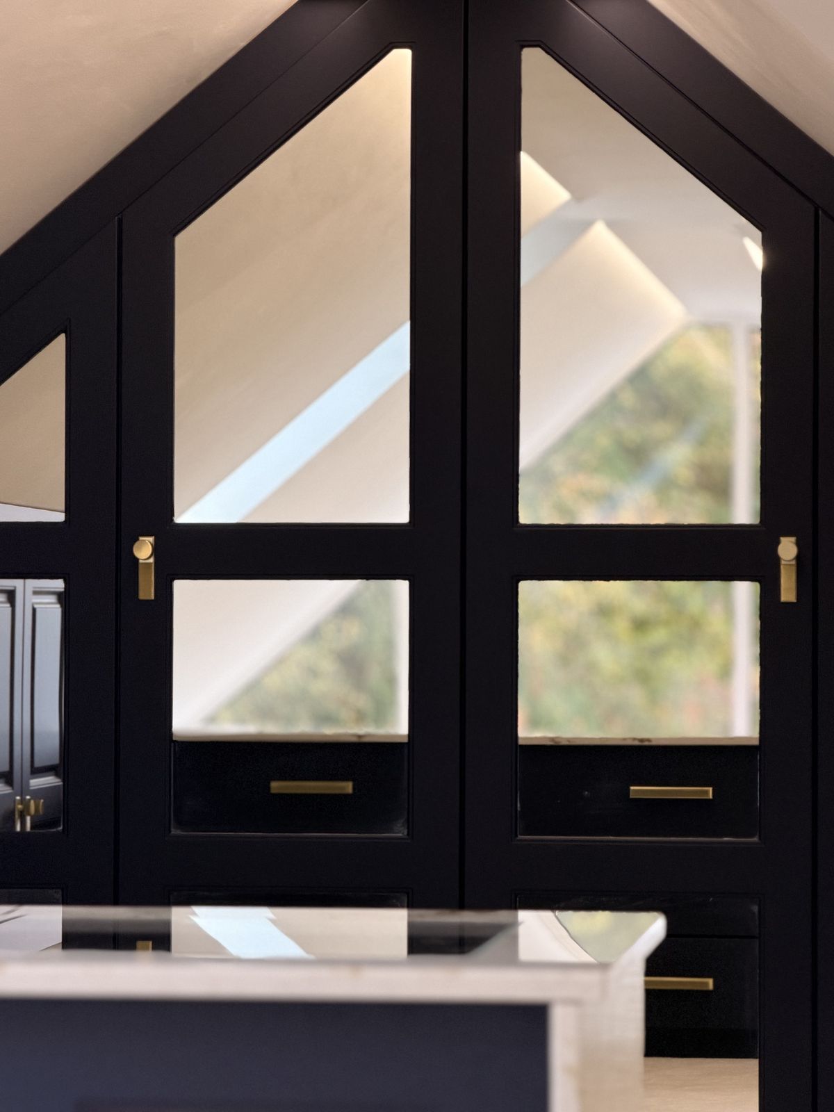 Glazed doors shaped to the pitch of the roof