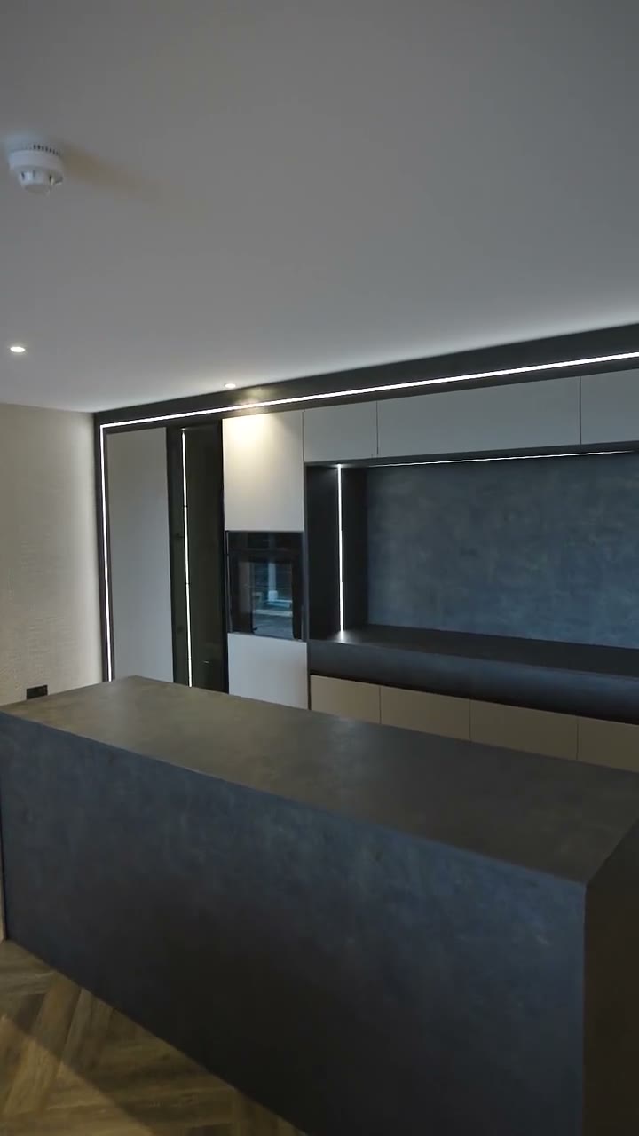 The handleless kitchen in the CEK showroom, with a charcoal island and tall units